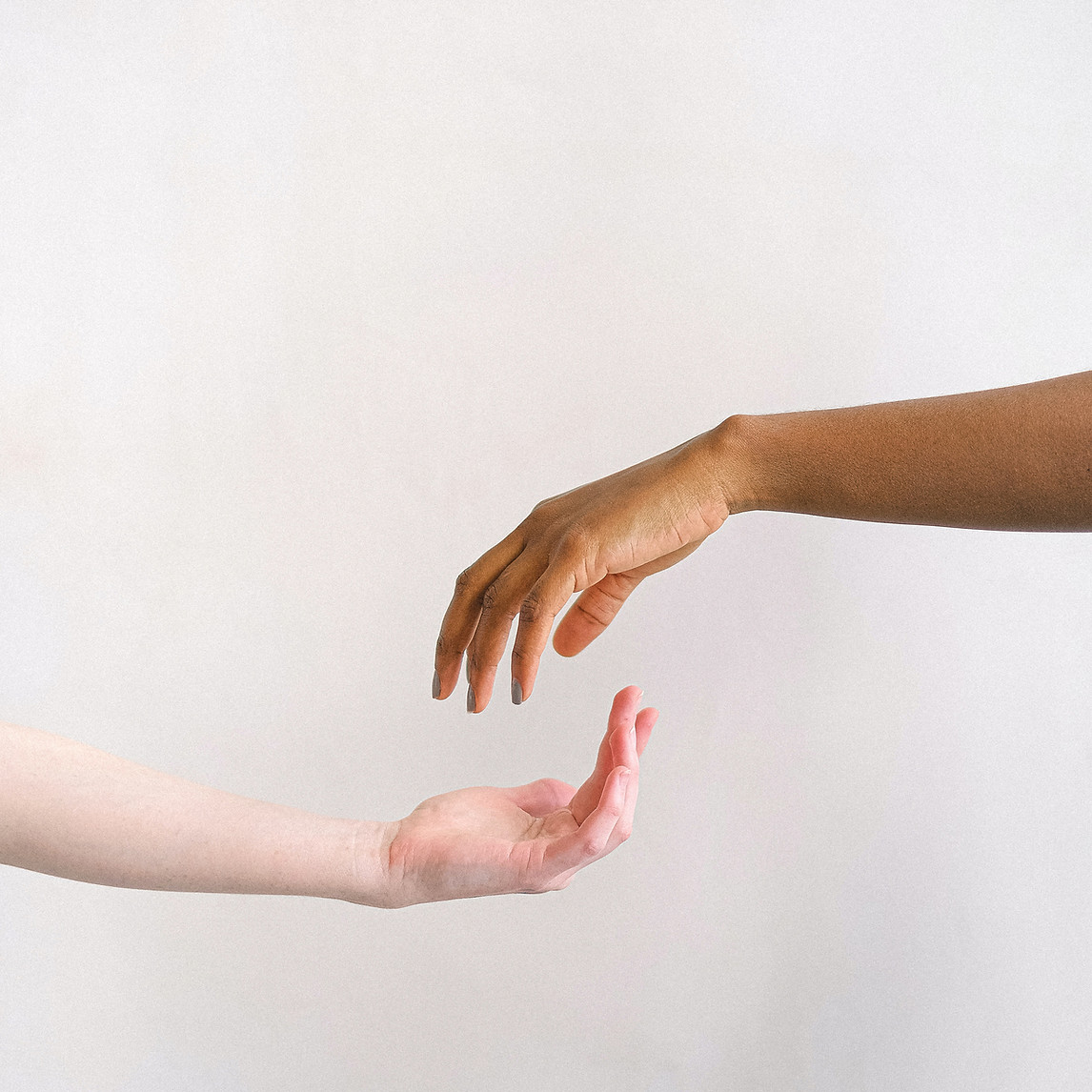 Two hands reaching toward each other